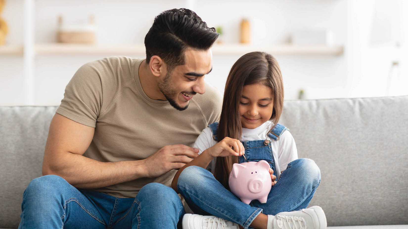 Daughter & Father With Piggy Bank